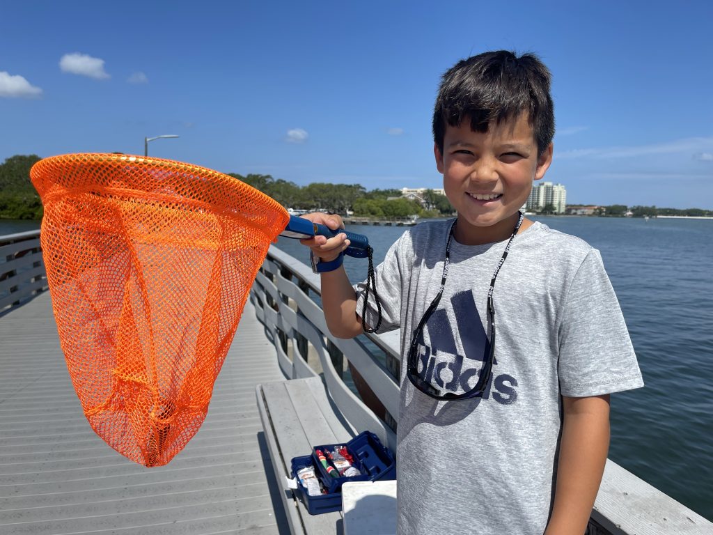 kid holding net kid holding fishing net